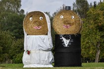 Bales of hay dressed up to look like a bride and groom