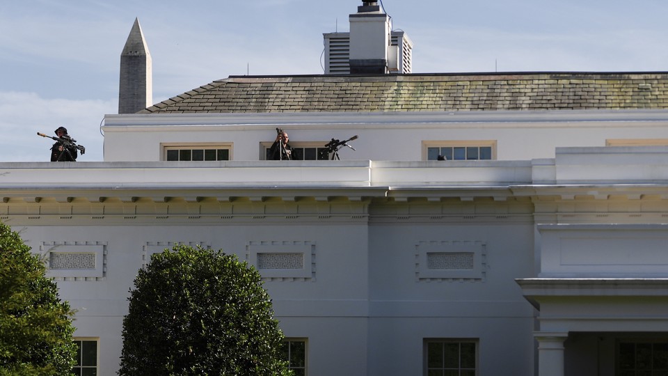 Secret Service snipers stand on the roof of the White House West Wing, Saturday, Aug. 9, 2025, in Washington.
