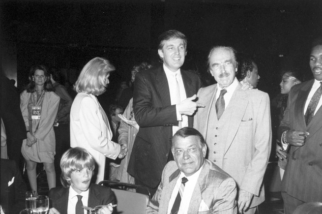 Trump and Don Jr. with Fred Trump (standing) in the Plaza Hotel in 1988