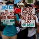 Activists display placards during a rally after 91 people were shot dead in the Philippines. 