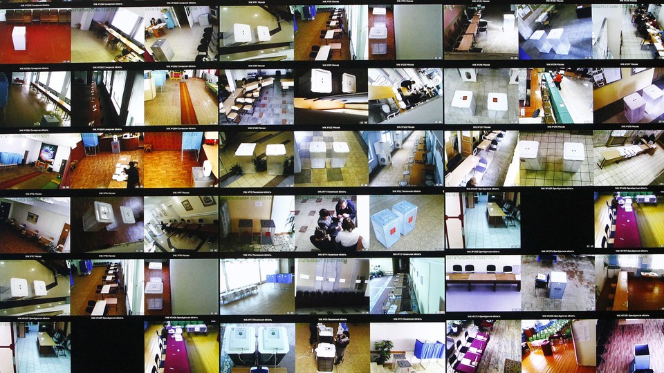 Screens show live footage from polling stations in Moscow during Russia's 2012 elections.