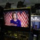 Nancy Pelosi appears on a video screen at the back of the White House press briefing room.