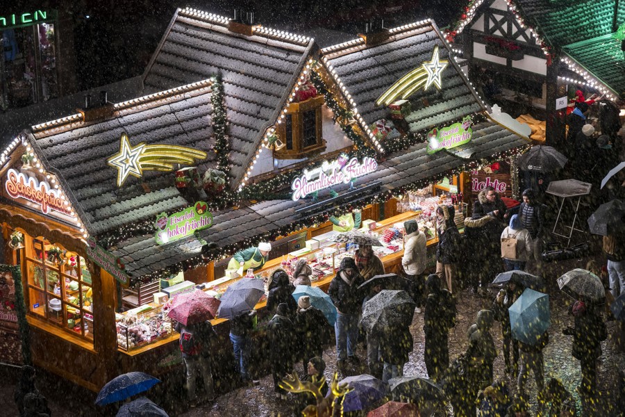 Visitors walk around Christmas-market stalls.