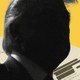 A photo illustration that includes Donald Trump in shadow and documents filled with redactions