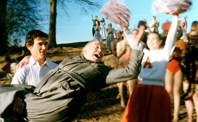 A young man holding his father in his arms