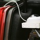 A white surveillance camera in the trunk of a car