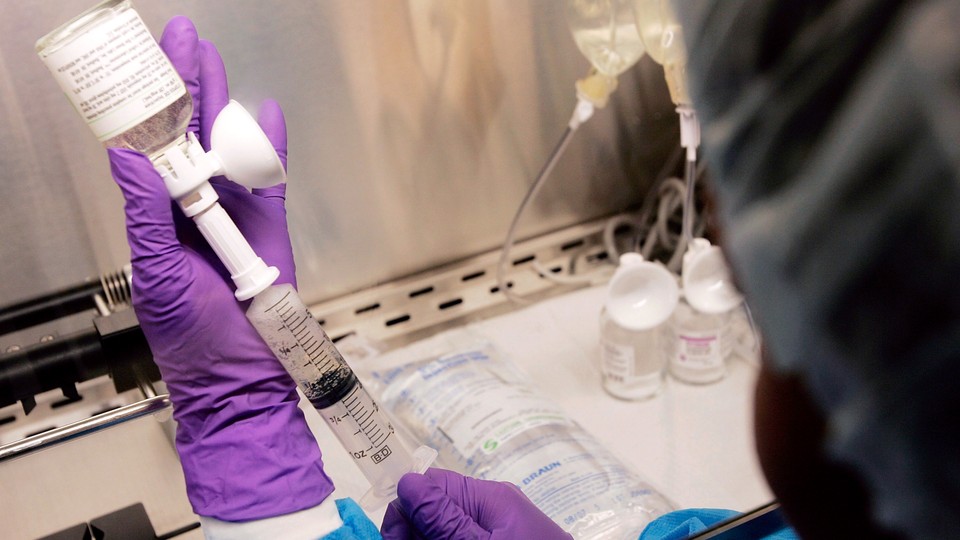 A doctor mixes a chemotherapy treatment.