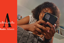 A young person looks at a smartphone.