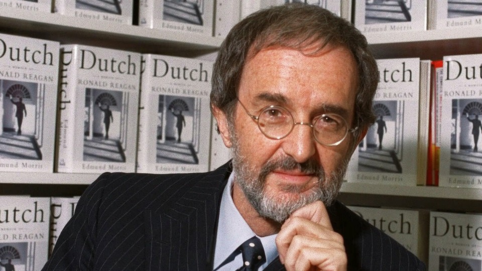 Edmund Morris in front of a shelf of "Dutch" copies