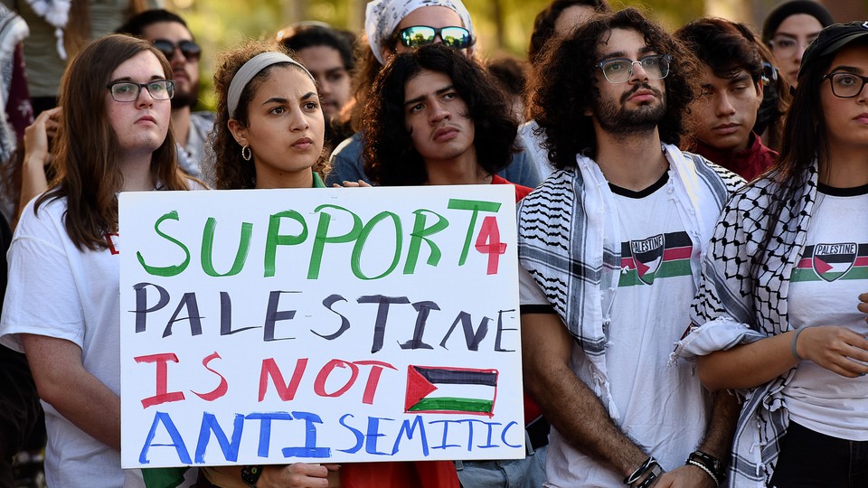 Students holding a sign in support of Palestine.