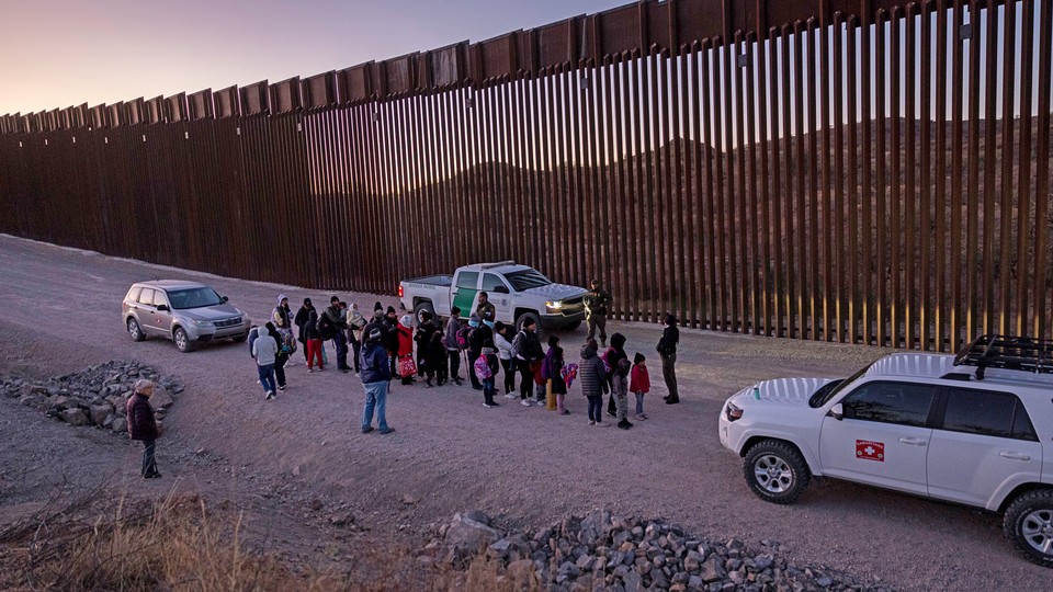 Border Patrol agents prepare to transport migrants.