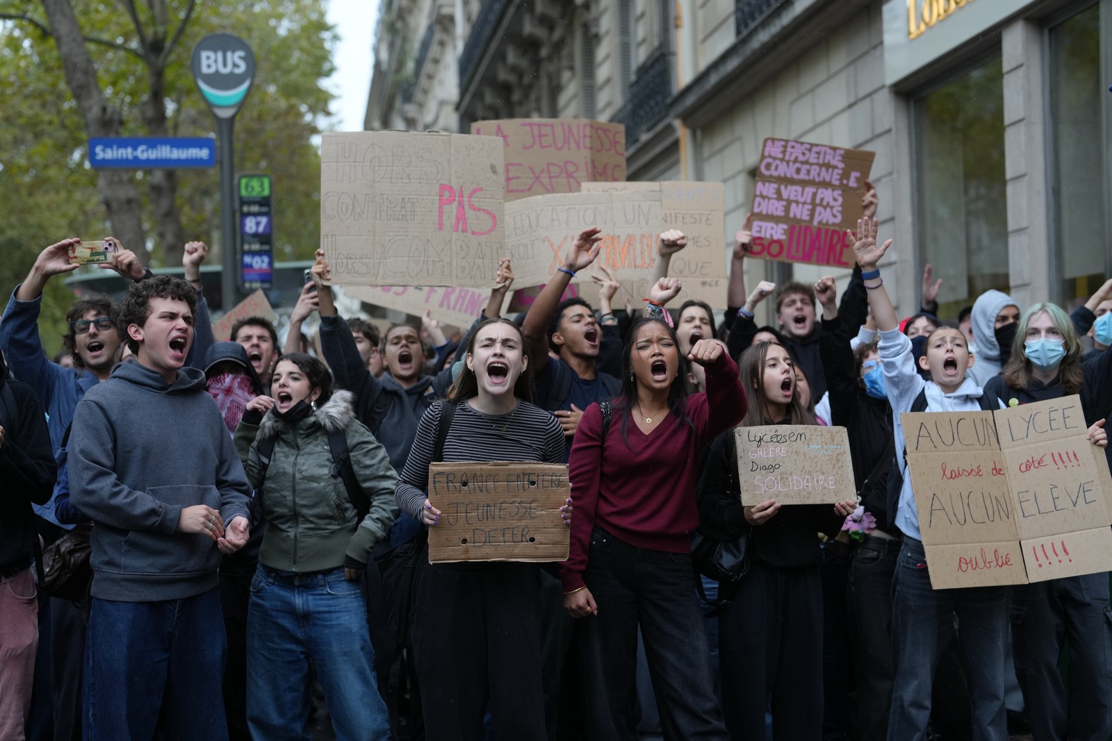 Protesting students chant in front of a blockaded high school.