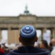 A man waits for the start of a demonstration against anti-Semitism in Berlin.