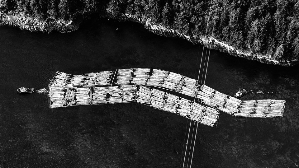 Tug boats move rafts of timber along the coast of Vancouver Island in Nanaimo, British Columbia, Canada, on Monday, May 10, 2021.