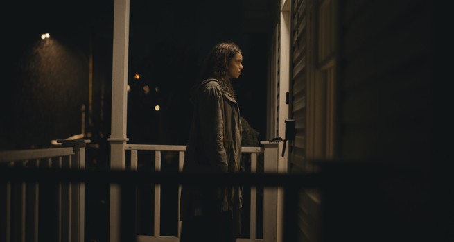 Georgina Campbell standing, with trepidation, at the door of her Airbnb in "Barbarian"