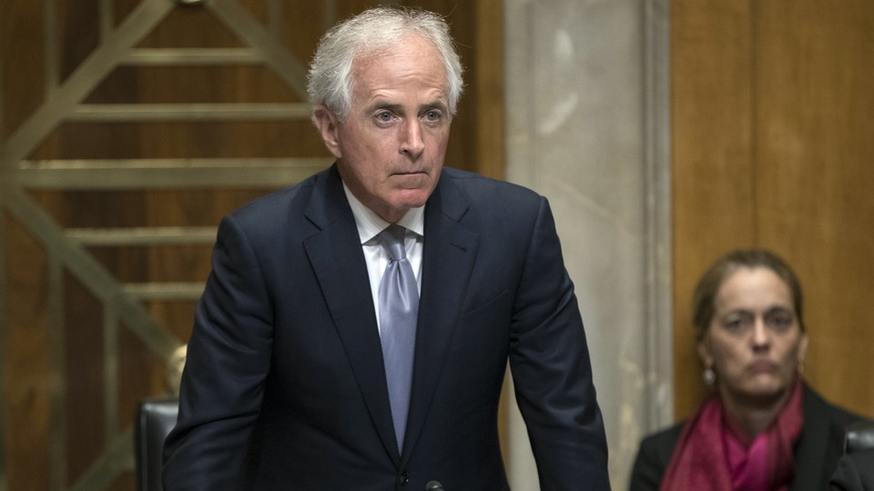 Senator Bob Corker of Tennessee stands in a hearing room.