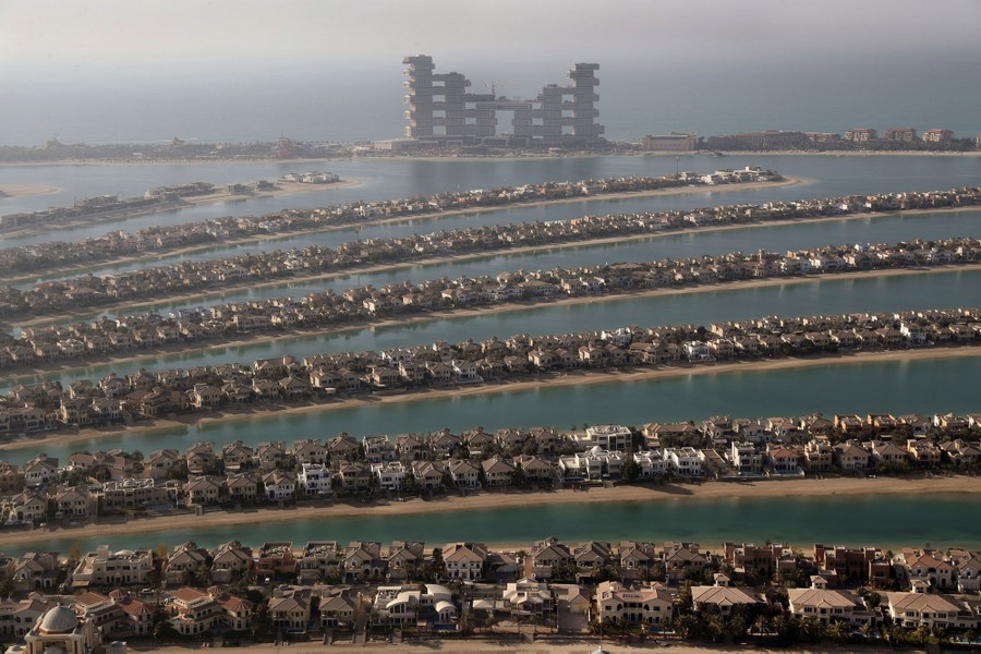 A view of hundreds of houses situated on narrow sand strips in a lagoon.