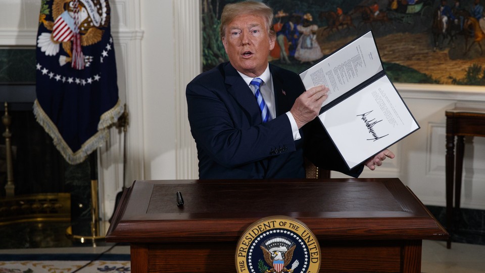 President Trump holding a signed memorandum