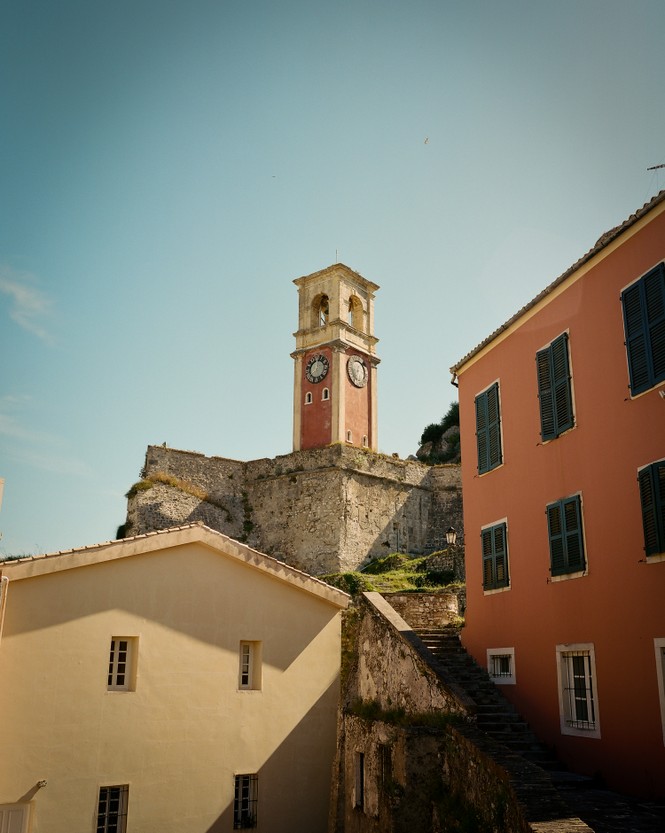 Picture of the clock tower of the Old Fortress in Corfu's view of Corfu’s Old Town at dusk.