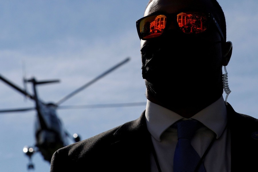 The facade of the White House is reflected in a Secret Service agent’s sunglasses.