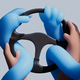 A black steering wheel with human hands surrounded and trapped by sinuous blue artificial arms and hands