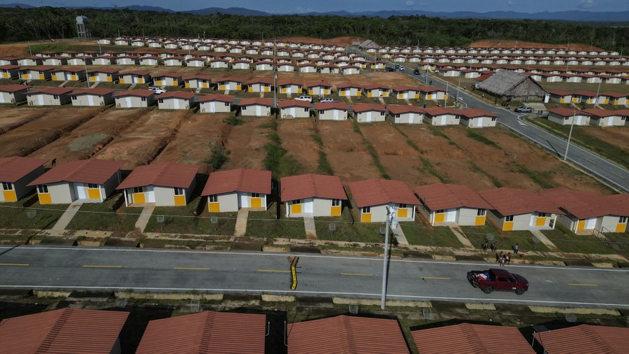 An elevated view of rows of dozens of small and very similar new houses