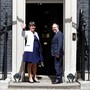 The leader of the Democratic Unionist Party (DUP), Arlene Foster, and the Deputy Leader Nigel Dodds, stand on the steps of 10 Downing Street before talks with Britain's Prime Minister Theresa May on June 13, 2017.