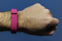 A person's arm with a fitness tracker on their wrist