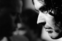 Black-and-white image of Russell Brand in profile
