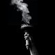 Black-and-white image of smoke rising from the Statue of Liberty's snuffed-out torch
