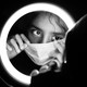 A woman putting on a surgical mask