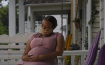 a pregnant person wears a face mask