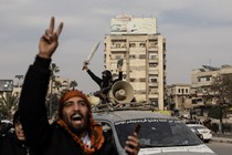 National Syrian Army soldiers celebrate in Hama, Syria, throwing up a peace sign