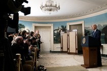 President Joe Biden at a press conference in front of many cameras and reporters