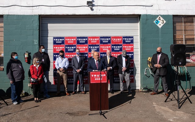 Rudy Giuliani holds a press conference outside a landscaping store.