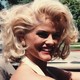 A profile shot of Anna Nicole Smith, driving a car.