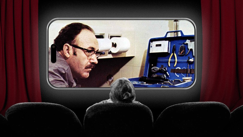 Person watching movie on IPhone.