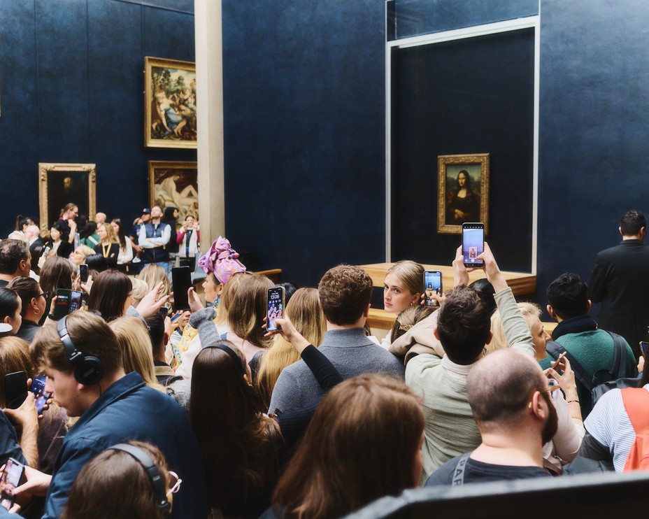 Picture of tourists taking photographs of Mona Lisa at The Louvre