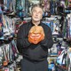 a portrait of Alec Baldwin holding a Trump mask