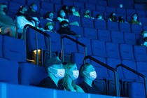 masked people in a movie theater