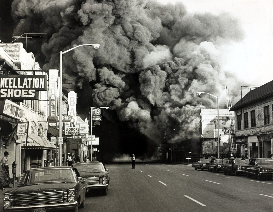 smoke billows over city street