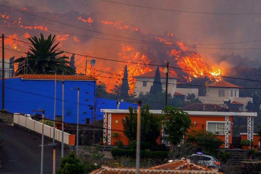Lava encroaches on a residential neighborhood.