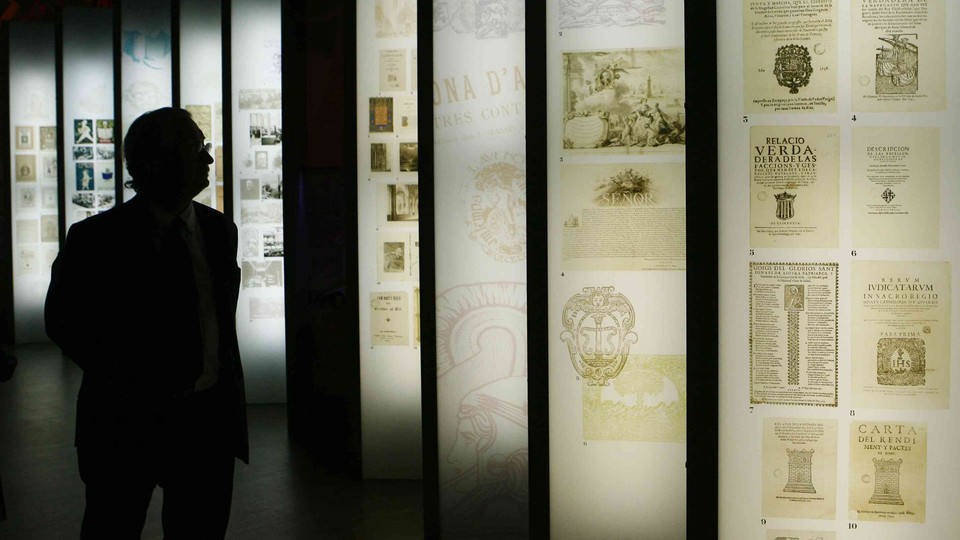 A man looks up at a series of informational panels.