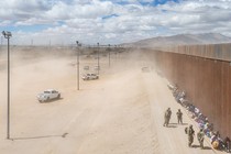 Photo of asylum seekers waiting along a border fence to be processed, March 2024, El Paso, Texas