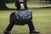 A military aide carries the "nuclear football," which contains launch codes for nuclear weapons