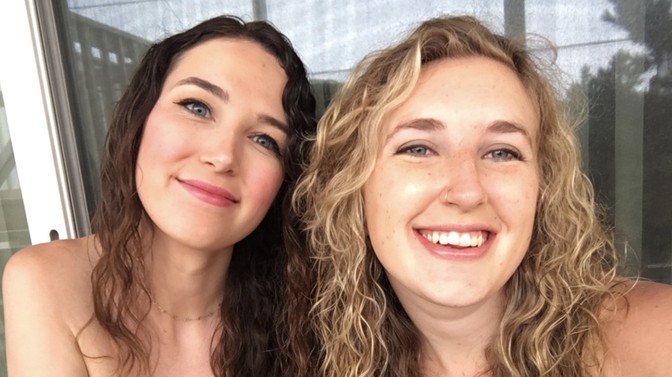 A close-up selfie of two smiling young women