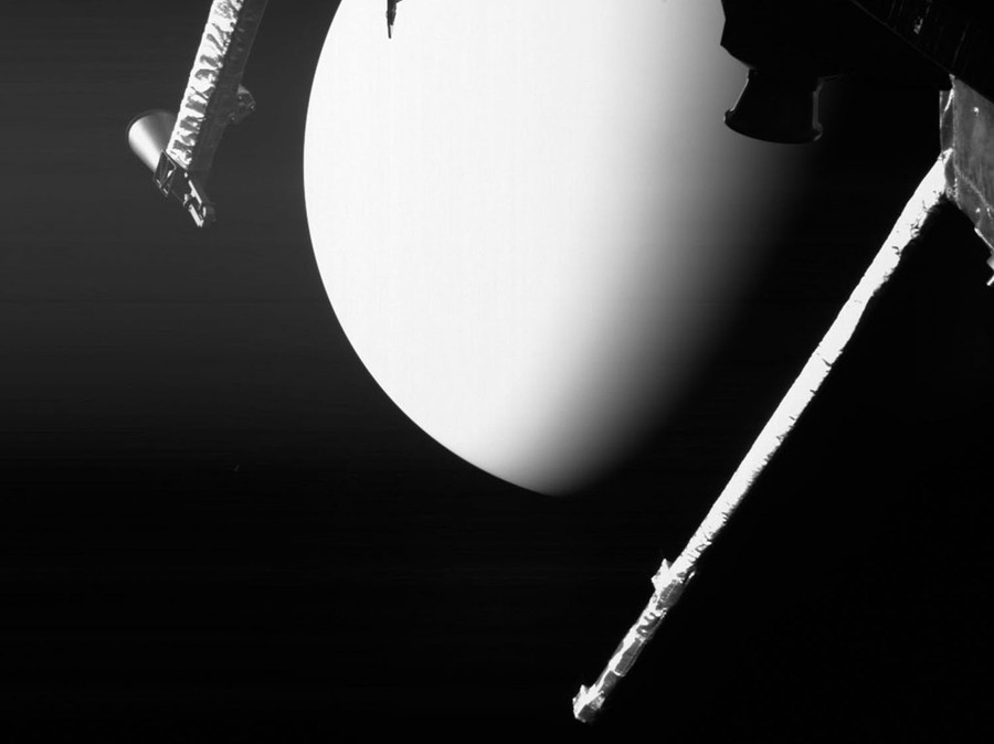 The smooth-looking surface of Venus is visible between instruments on a spacecraft.