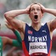 A runner reacts, hands to head, after setting a world record.