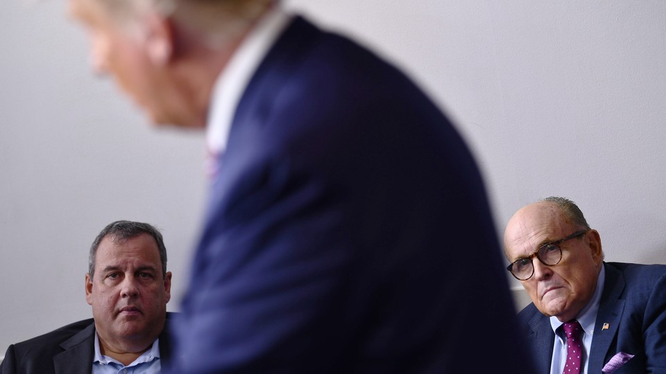 Former New Jersey Governor Chris Christie and former New York City Mayor Rudy Giuliani listen while President Donald Trump speaks during a briefing at the White House on September 27.