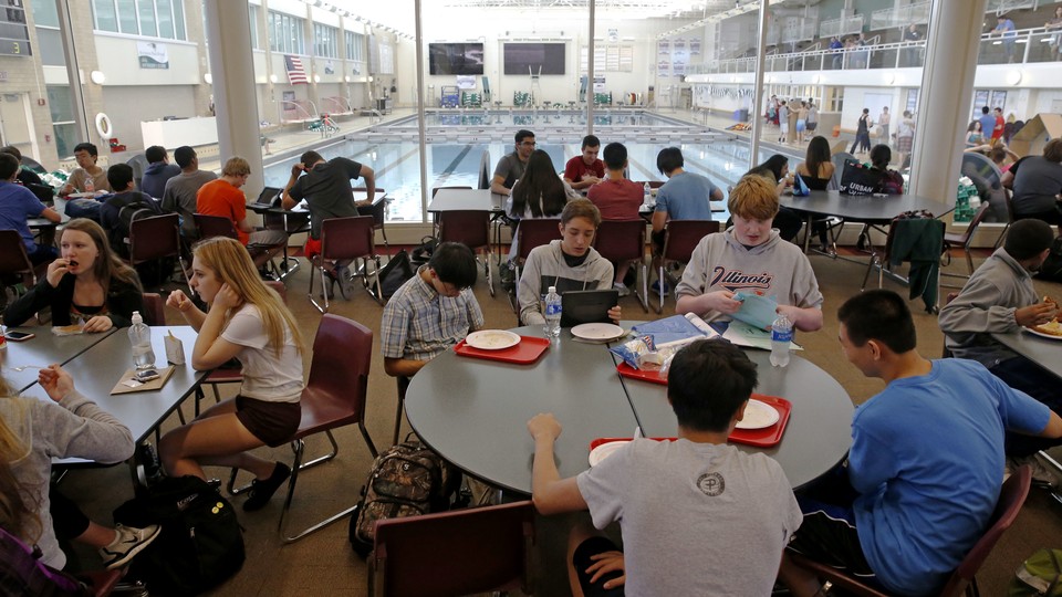 Students eat lunch in a cafeteria 
